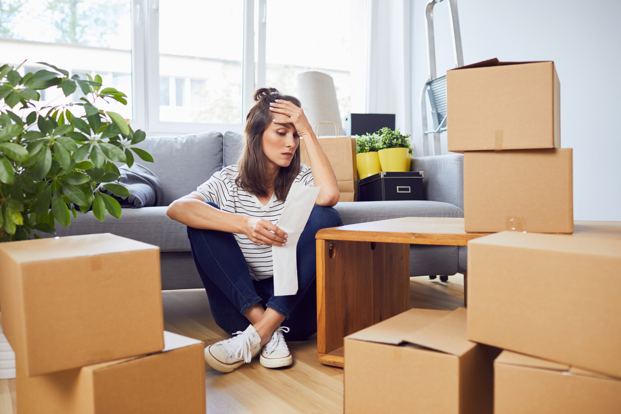 woman sitting with moving boxes